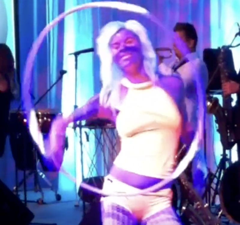Roving dancefloor act with hoops entertaining guests on a harbour cruise
